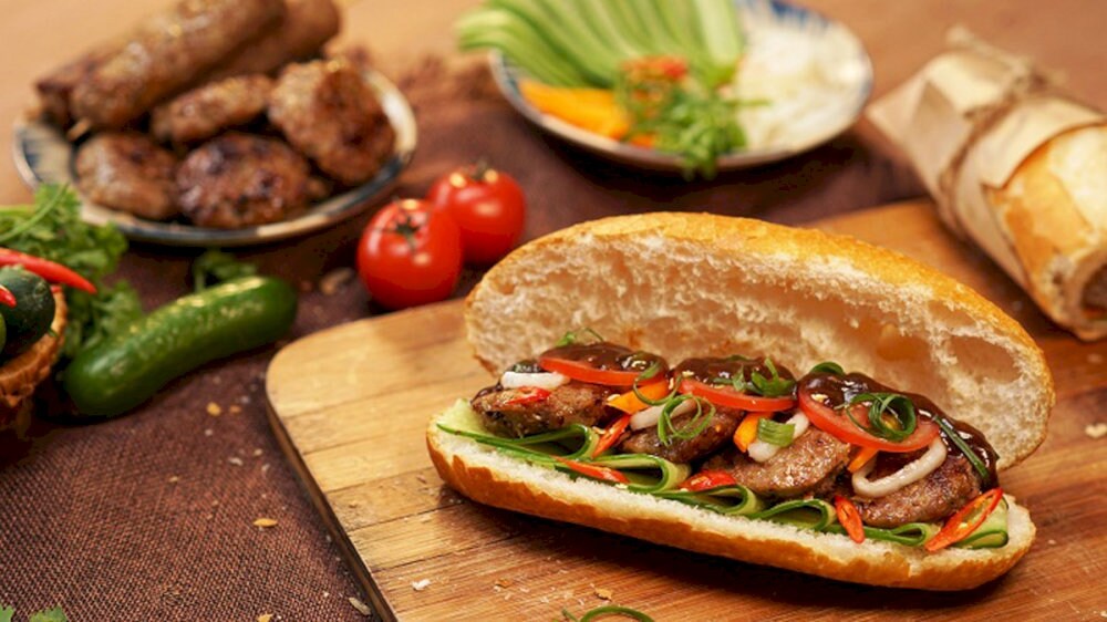 Their banh mi is served warm, packed with flavorful meat, and topped with fresh vegetables and herbs